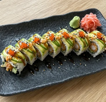 Dragon Roll topped with avocado, eel sauce and tobiko, with ginger and wasabi